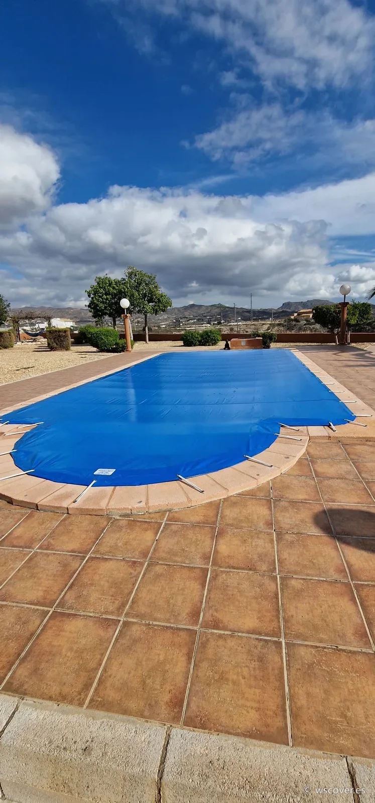 Winter PVC cover on a pool with a Roman-end step