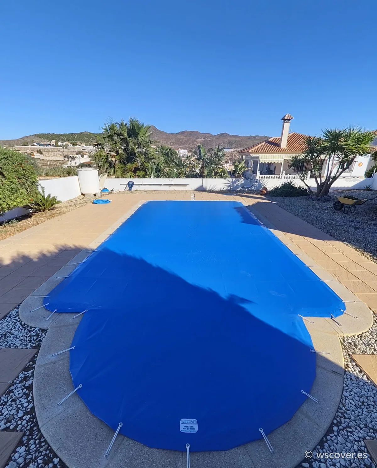 Winter PVC cover on a pool with a Roman-end step